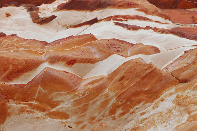 A wall of orange stone twists and turns in the Australian outback.
