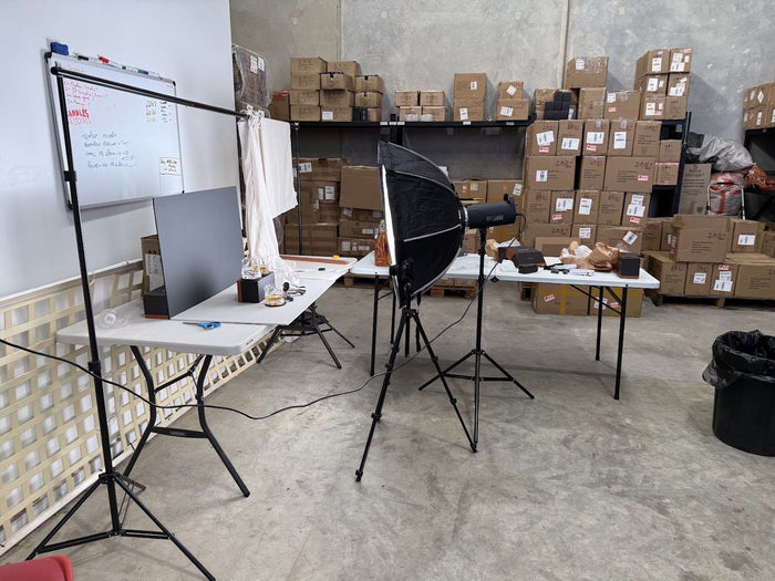 The budget photo studio in the warehouse: one softbox, a folding table, June 2025